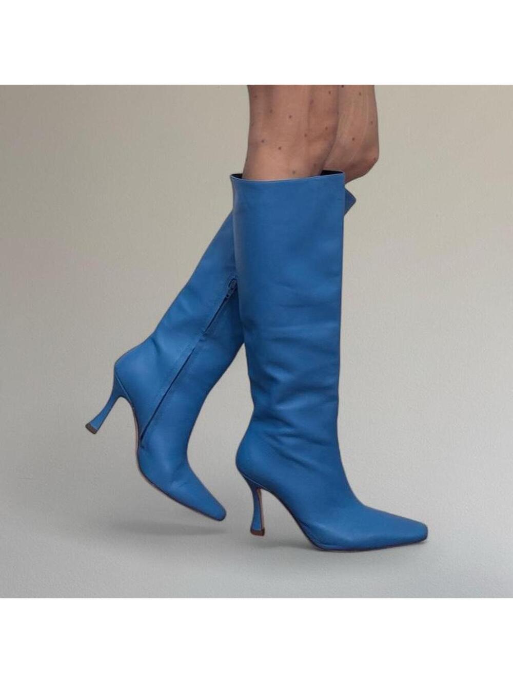 Staud neon blue knee high heeled boots.